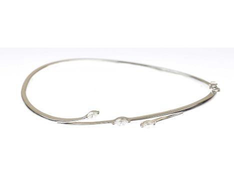 A diamond set hinged bangleSet with three marquise-cut diamonds, to a plain 18k white gold bangle, concealed box clasp, total
