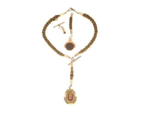 A late Victorian hair work watch chain and fobsEach section of braided hair terminating in rose-metal hexagonal barrels, two 