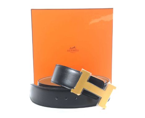A Hermes leather belt The soft black leather belt, with exposed stitching and tan leather interior, with embossed marks, with