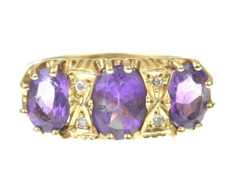 An amethyst and diamond ringThe oval shape graduated amethysts, with single-cut diamond highlights, in 18k gold, ring size Q 