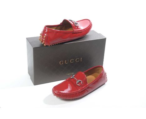 A pair of Gucci patent red leather ladies loafers The vibrant cherry red leather, with rubber studded sole and burnished silv