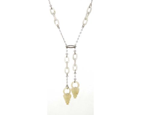 An impressive Art Deco jade, diamond and enamel negligee pendant necklaceThe white enamel chain, with alternating carved jade