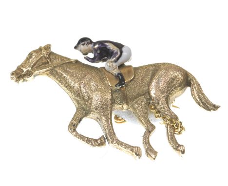 Of equestrian interest: An enamel novelty broochRealistically modelled as a racing horse and jockey, the jockey with enamel d