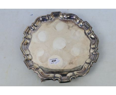 A silver salver with pie crust rim, raised on tripod scroll supports, Sheffield assay, approximately 803 grams / 25 ozt.