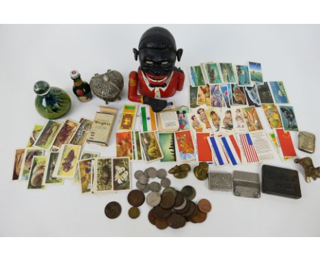 Lot to include a novelty money bank, Mdina paperweight, coins, tea cards, trinket box and similar.Note: Mechanical cast iron 