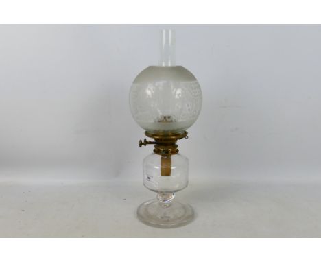 A heavy glass oil lamp with star cut base and clear glass shade, approximately 50 cm (h).