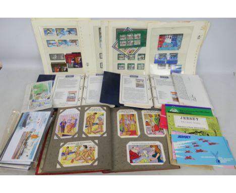 Lot to include an album of comic postcards, in excess of 80 cards, two Locomotive Philatelica albums with contents. loose sta