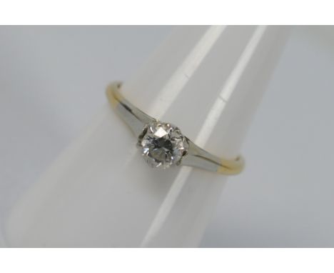 A two-tone, solitaire ring, stamped 18ct, size O, approximately 2.2 grams all in.
