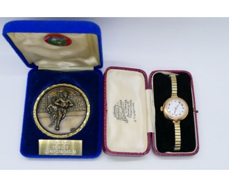 A lady's vintage 9 carat gold cased watch stamped 9; 375, Roman numerals on a white dial measuring 19 mm diameter, mechanical