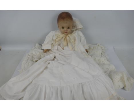 Reliable Doll - A vintage doll made by Reliable (Canada). The composite baby doll with weighted eyes and open mouth, features