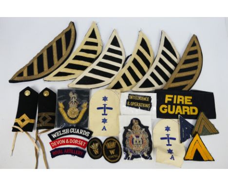 Various cloth insignia to include Kings Own Scottish Borderers patch, musician epaulettes, shoulder boards and similar.