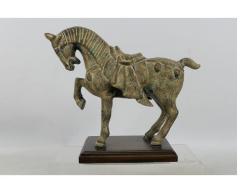 A Japanese cast metal model of a horse mounted to wooden plinth, approximately 24 cm (h).