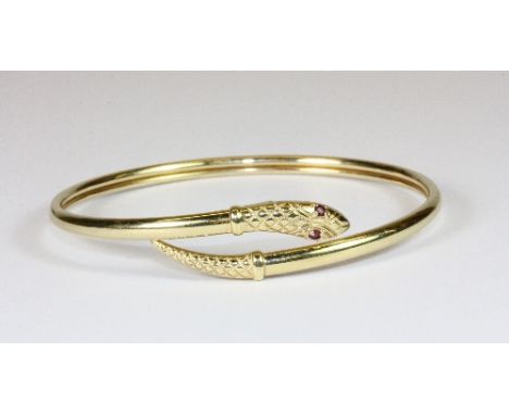 A 9ct gold snake bangle with ruby eyes
