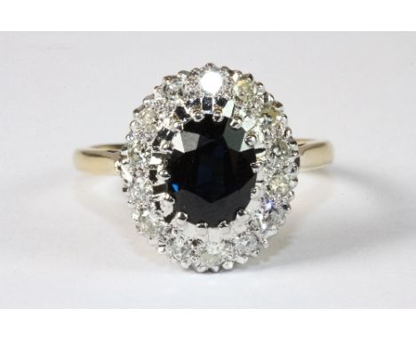 An 18ct yellow gold sapphire and diamond cluster ring. Size Q