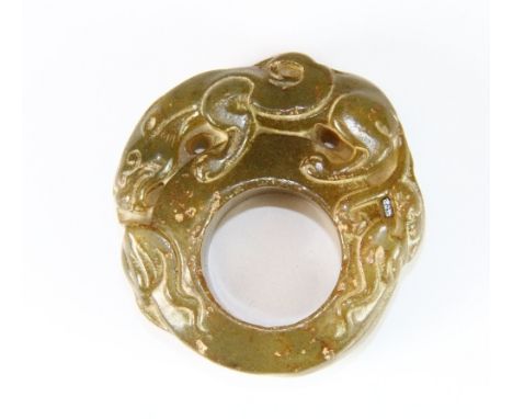 An unusual olive green jade mandarin's signet ring carved with a dragon (Z+2)