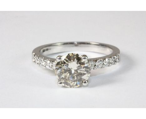 An 18ct white gold ring set with a solitaire diamond approx. 1.75ct with diamond set shoulders. Size N. Est. £2800 - 3500