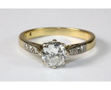 An 18ct yellow gold ring set with a solitaire diamond approx. 0.9ct with diamond set shoulders. Size N