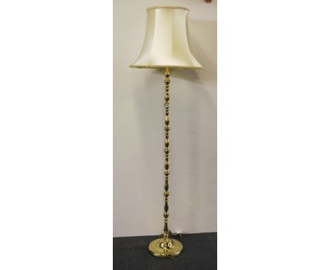 A gilt brass standard lamp and silk shade