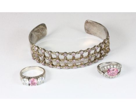 A silver bangle and two silver rings set with rose quartz and other stones