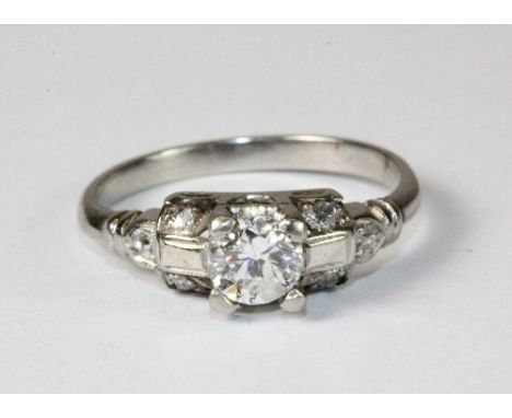 A lovely platinum and diamond Art Deco style solitaire ring with diamond set shoulders (K) includes Bakelite box