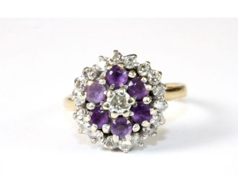 An 18ct gold diamond and amethyst cluster ring (J.5)