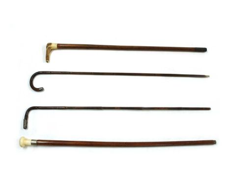 A collection of walking sticks, to include an ivory handled example with silver collar and ebony shaft, 91cm, a similar examp