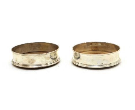 A matched pair of sterling silver wine coasters, one by Mills &amp; Hershey, London 1978, the other by M C Hersey &amp; Son L