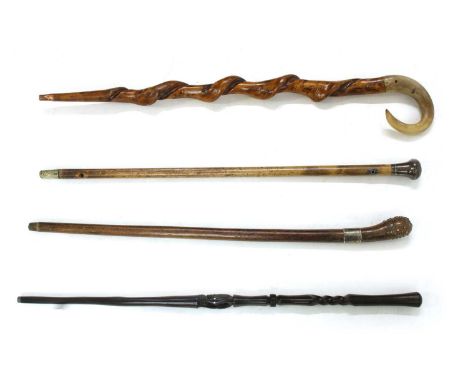 A collection of walking sticks, to include a silver handled palmwood stick, London 1910, 91cm, a similar horn handled example