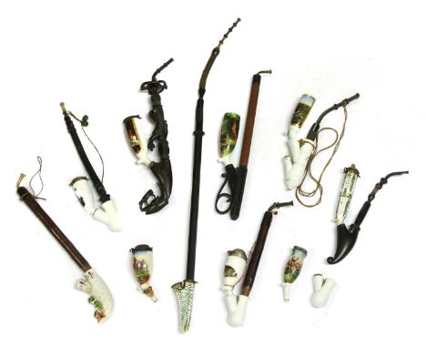Eight German porcelain pipes, each painted or printed with hunting subjects, one with an intricately carved horn shaft modell