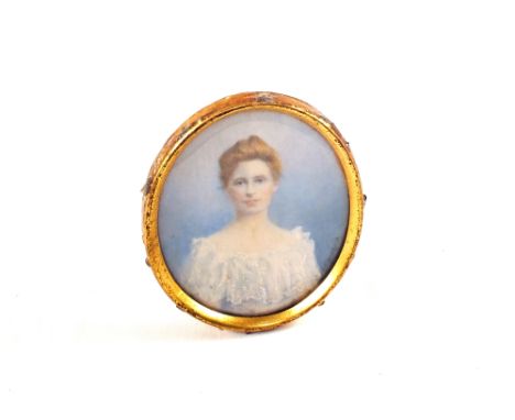 An oval portrait miniature of head and shoulders of a lady
