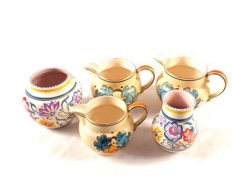 Two Poole floral vases and a set of three Grays pottery jugs