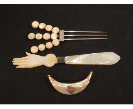 A Mother of Pearl letter opener, a hair comb and a 9ct Gold and Mother of Pearl brooch