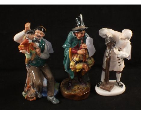 Three Royal Doulton figurines, The Puppet Maker HN 2253, The Mask Seller HN 2103 and The Wig Maker of Williamsburg HN 2239