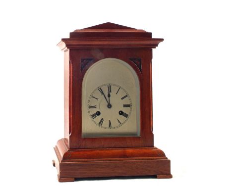 A Mahogany striking mantel clock and a Remingtons portable typewriter