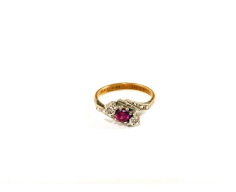 An 18ct Gold three stone ring, the central pink stone with two illusion set Diamonds and Diamond set shoulders, size K