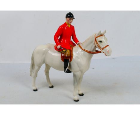 A Beswick huntsman on white horse, 21 cm (h). [W]

Condition Report: Appears in good condition, no chips, cracks, hairlines o