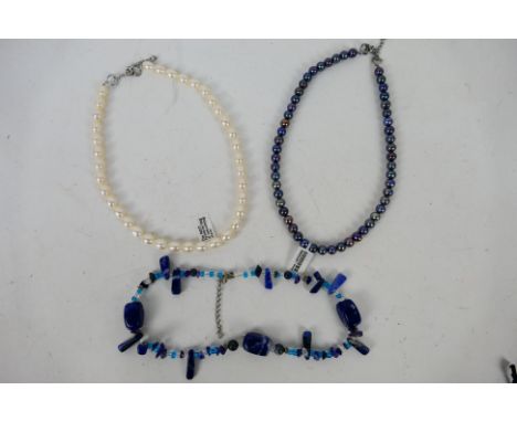 A black pearl necklace, a lapis lazuli necklace and similar