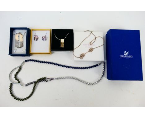 Boxed costume jewellery to include a Swarovski crystal and pearl bead necklace, necklace with pendant and ear studs in the fo