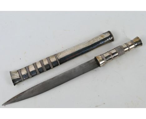 A Bhutanese dagger with white metal and wire bound hilt and scabbard, blade 15 cm (l). [W]

Note: This lot is not for sale to