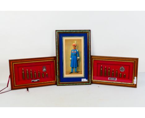 Two framed cap badge and bullet displays comprising RAF and Queens Lancashire Regiment, each approximately 23 cm x 37 cm and 