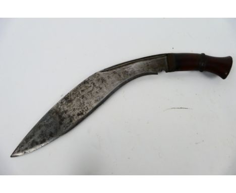 A vintage kukri knife with 29 cm (l) blade and wooden hilt. [W]

Note: This lot is not for sale to people under the age of 18