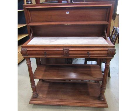 A 19th century walnut buffet on three tiers enclosing two frieze drawers beneath a marble top, the raised back lowered to cov