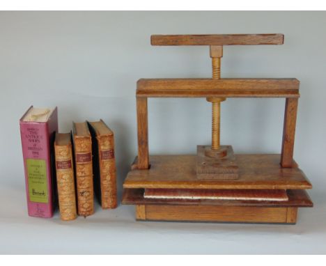Early 20th century oak book press with scalloped handle, 41cm long, together with a collection of vintage books