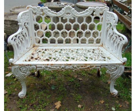 A good quality reproduction cast iron two seat garden bench with scrolled outline and decorative pierced detail, 109 cm wide 