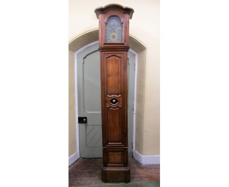 An early 19th century oak continental longcase clock with moulded framework, the hood with arch enclosing a broken arch brass