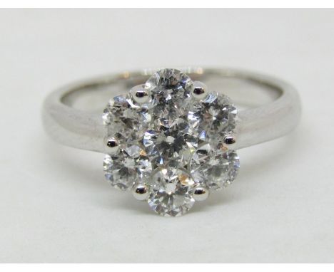 Good seven stone diamond cluster ring, centre stone 0.20cts approx, in 18ct white gold, stamped 'D 1.30', size O, 5.1g