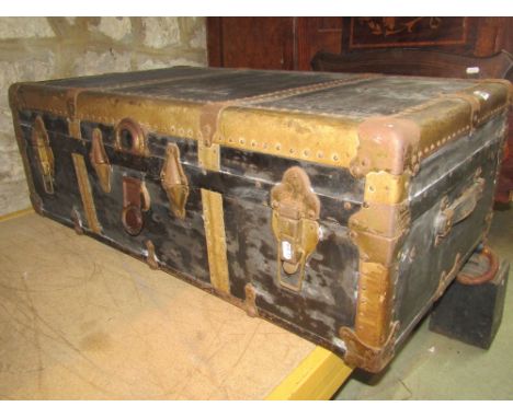 A vintage C &amp; M vulcanised hard fibre bound travelling trunk with stitched leather carrying handles containing a further 