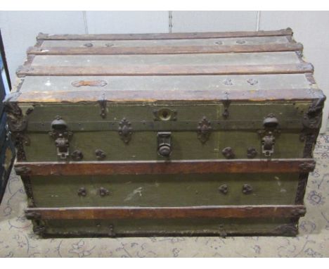 A substantial Edwardian travelling trunk, canvas covered with timber and steel banded lathes