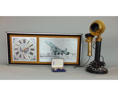 Vintage brass and cast metal candlestick telephone, together with a further Concorde novelty wall clock and further Concorde 