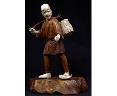 Japanese Meiji period boxwood okimono in the form of a standing fisherman, inset calligraphy signature to base, 17 cm high